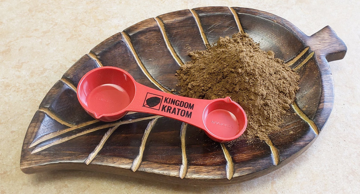 Chocolate Kratom Powder on leaf tray with branded scoop - Top View | Kingdom Kratom